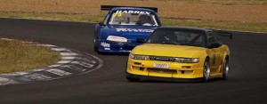 A battle in the Sports Sedan/Touring Car race at Queensland Raceway's Shannons 2 Days of Thunder