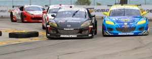 The Mazda RX8s battle in the GT Class of the Grand Am race at Detroit