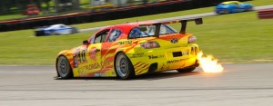 The Dempsey Racing Mazda RX-8 spits flame at Mid Ohio