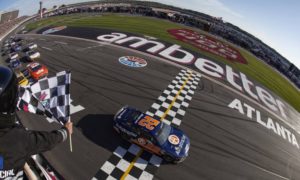 HAMPTON, GEORGIA – MARCH 19: Joey Logano, driver of the #22 Autotrader Ford, takes the checkered flag to win the NASCAR Cup Series Ambetter Health 400 at Atlanta Motor Speedway on March 19, 2023 in Hampton, Georgia. (Photo by Sean Gardner/Getty Images)